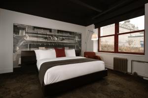 a bedroom with a large bed and a window at Hôtel Le Germain Québec in Quebec City +30 photos