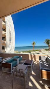 a balcony with a view of the beach at Beachfront condo in Progreso in Telchac Puerto