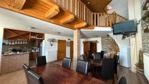a dining room with a wooden table and chairs at Atkári Vendégház in Bóly
