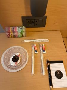 a table with a plate and utensils on it at Algo Hotel Tirana in Tirana