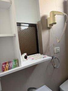 a bathroom with a sink and a mirror on the wall at Algo Hotel Tirana in Tirana