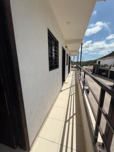 a balcony of a building with a window and shadows at Departamentos MIRAMONTES in Guaymas