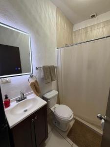 a bathroom with a toilet and a sink and a shower at Departamentos MIRAMONTES in Guaymas