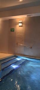 a swimming pool with blue water in a room at Triventi Apartament Rajski in Karpacz