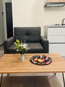 a plate of fruit on a coffee table in front of a couch at Vista Studio in Bakuriani