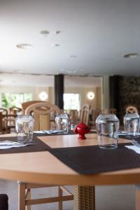 a table in a restaurant with glasses on it at Oro Hotel in Policoro