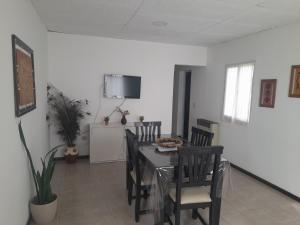 a dining room with a table and chairs at Complejo Vélez Sarsfield 185 in Bell Ville +5 photos