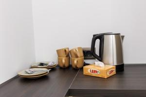 a counter with a coffee pot and shoes and a box at Lchak Hotel in Yeghegnadzor