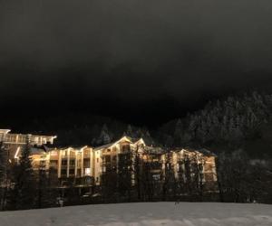 a large building in the snow at night at Vista Studio in Bakuriani