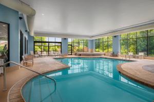 a large swimming pool with blue water in a building at Garner Hotel Wadsworth by IHG in Wadsworth