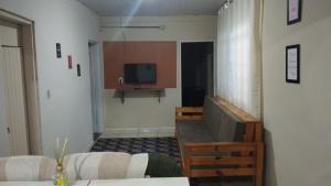 a living room with a television and a couch at Casa cantinho da Rubi in Atibaia
