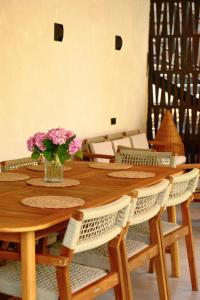 a wooden table with a vase of flowers on it at Racha Roots Boutique House in Ambrolauri +15 photos