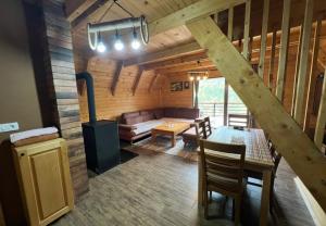 a living room with a woodburning stove in a cabin at Villa Albani in Peje