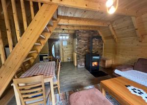 a living room with a staircase in a log cabin at Villa Albani in Peje
