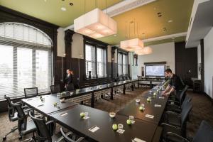 a group of people standing at tables in a room at Hôtel Le Germain Québec in Quebec City
