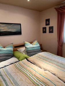 a bedroom with two beds with pillows at Haus Schneebergblick in Röslau