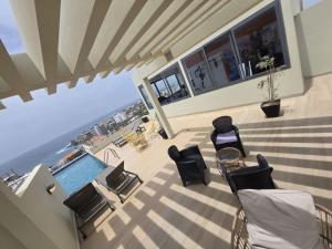 a view of a balcony with a pool and chairs at Elegance appart-Yoff virage in Dakar