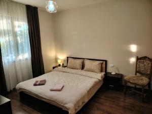 a bedroom with a bed with two towels on it at Къща за гости Азария in Resilovo +10 photos