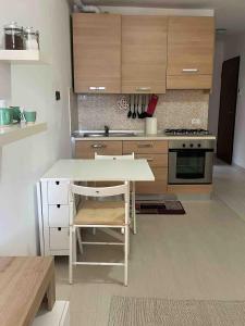 a kitchen with wooden cabinets and a table and a stove at Studio apartment on the lake in Lovere +4 photos