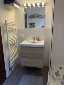 a bathroom with a sink and a mirror at Studio apartment on the lake in Lovere