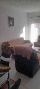 a bedroom with two beds and a desk and a chair at Apartment LUX in Struga