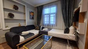 a room with a bed and a couch and a window at The King Suit Beşiktaş in Istanbul