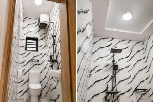 a bathroom with a black and white marble wall at Seychelles Bella House in Mahe