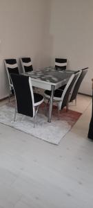 a dining room table with chairs around it at Apartment LUX in Struga +3 photos