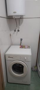a washing machine in a corner of a room at Apartment LUX in Struga