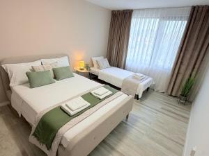 a hotel room with two beds and a window at River view Kardzhali in Kŭrdzhali