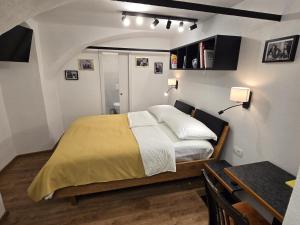 a bedroom with a bed and a table and a table sidx sidx sidx at Ludo Rooms in Radlje ob Dravi