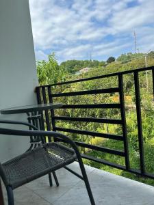 a chair sitting on a balcony with a view at Four seasons in Kutaisi +10 photos