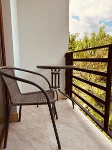 a table and a chair on a balcony at Four seasons in Kutaisi