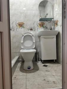 a bathroom with a toilet and a sink at Four seasons in Kutaisi