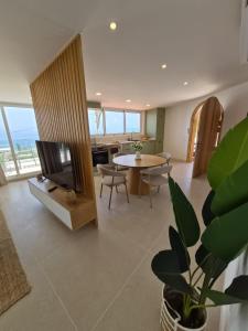 a living room with a table and a dining room at Gándara Lodge Luxury in Tijoco de Abajo +27 photos