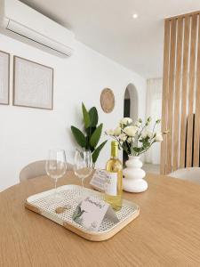 a table with two glasses and a bottle of wine at Gándara Lodge Luxury in Tijoco de Abajo