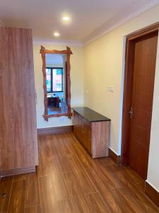 an empty room with a table and a mirror at Progressive Park Hotel in Nairobi