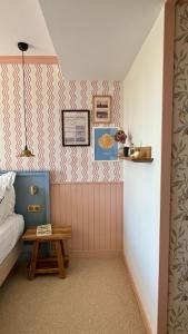a small room with a bed and a table at Hotel Saint-Enogat in Dinard