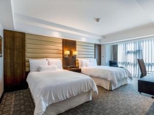 a hotel room with two beds in a room at Swissotel Lima in Lima +171 photos