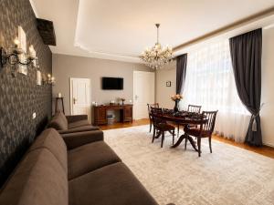 a living room with a couch and a table at Mozart & Bach Historic Apartment in Sibiu
