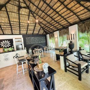 a room with a table and chairs and a kitchen at Terra Taina Boutique Bed&Breakfast in Las Terrenas