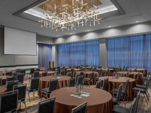 a conference room with tables and chairs and a projection screen at Fairmont Pittsburgh in Pittsburgh