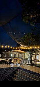 a patio with a table and lights at night at Cazabela in Casisang