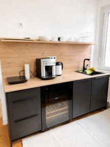 a kitchen with a counter with a coffee maker on it at Altstadt-Loft Würzburg in Würzburg