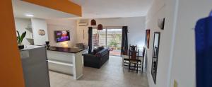 a kitchen and a living room with a counter top at Nuestra Recova en Pilar BsAs in Pilar