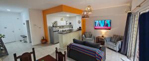 a living room with a couch and a kitchen at Nuestra Recova en Pilar BsAs in Pilar