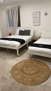 a room with three beds and a rug on the floor at Holiday Plus - 50 Palatine Road in Blackpool