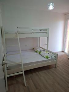 a bunk bed with a ladder in a room at Rafaelo Apartament in Lezhë
