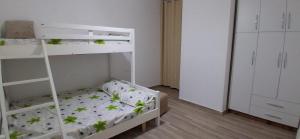 a bedroom with a bunk bed with leaves on it at Rafaelo Apartament in Lezhë