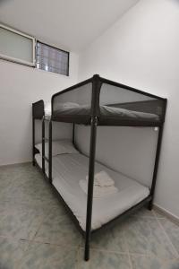 a black bunk bed sitting in a room at Gran Paradiso Guest House in Tivoli